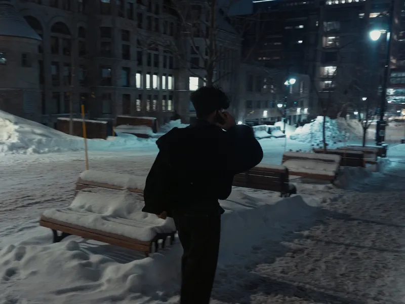Malik walking through fresh snow in Montreal at night